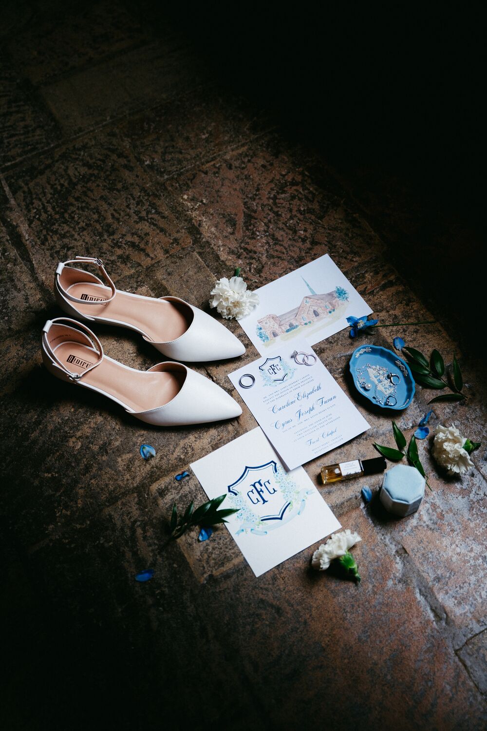 Bridal details styled on rich leather — heels and hand-lettered stationery