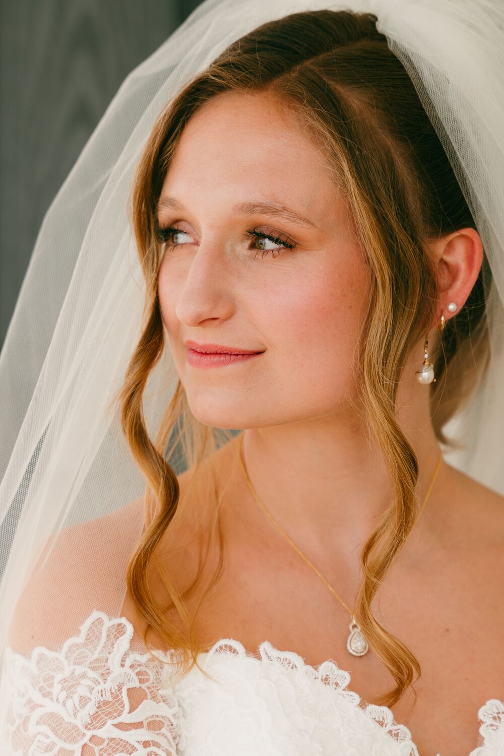 A bride in profile, veil catching the window light