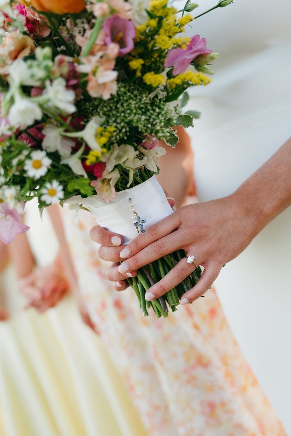 The bouquet held close — a quiet detail of the day