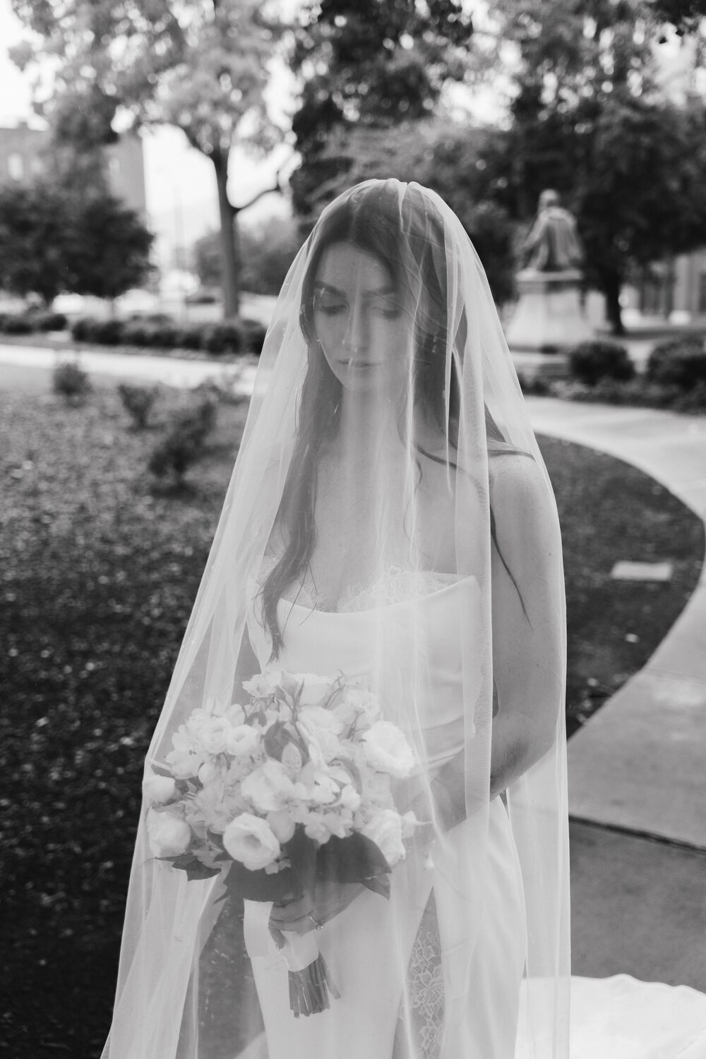 A bride beneath her veil, in black and white
