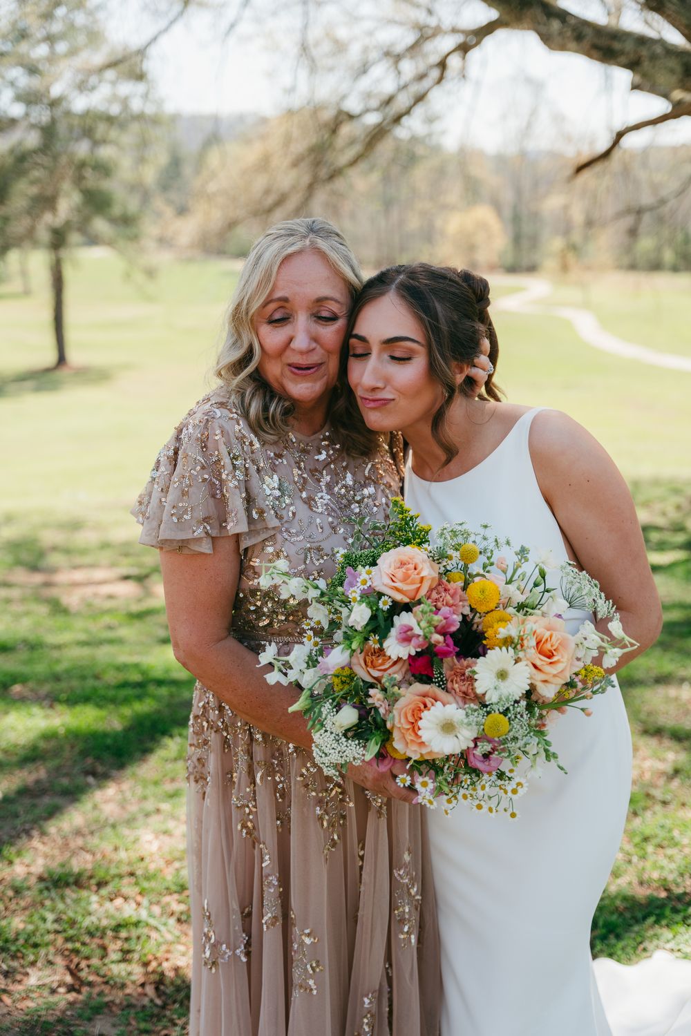 Ellie sharing a quiet embrace with her mother before the ceremony