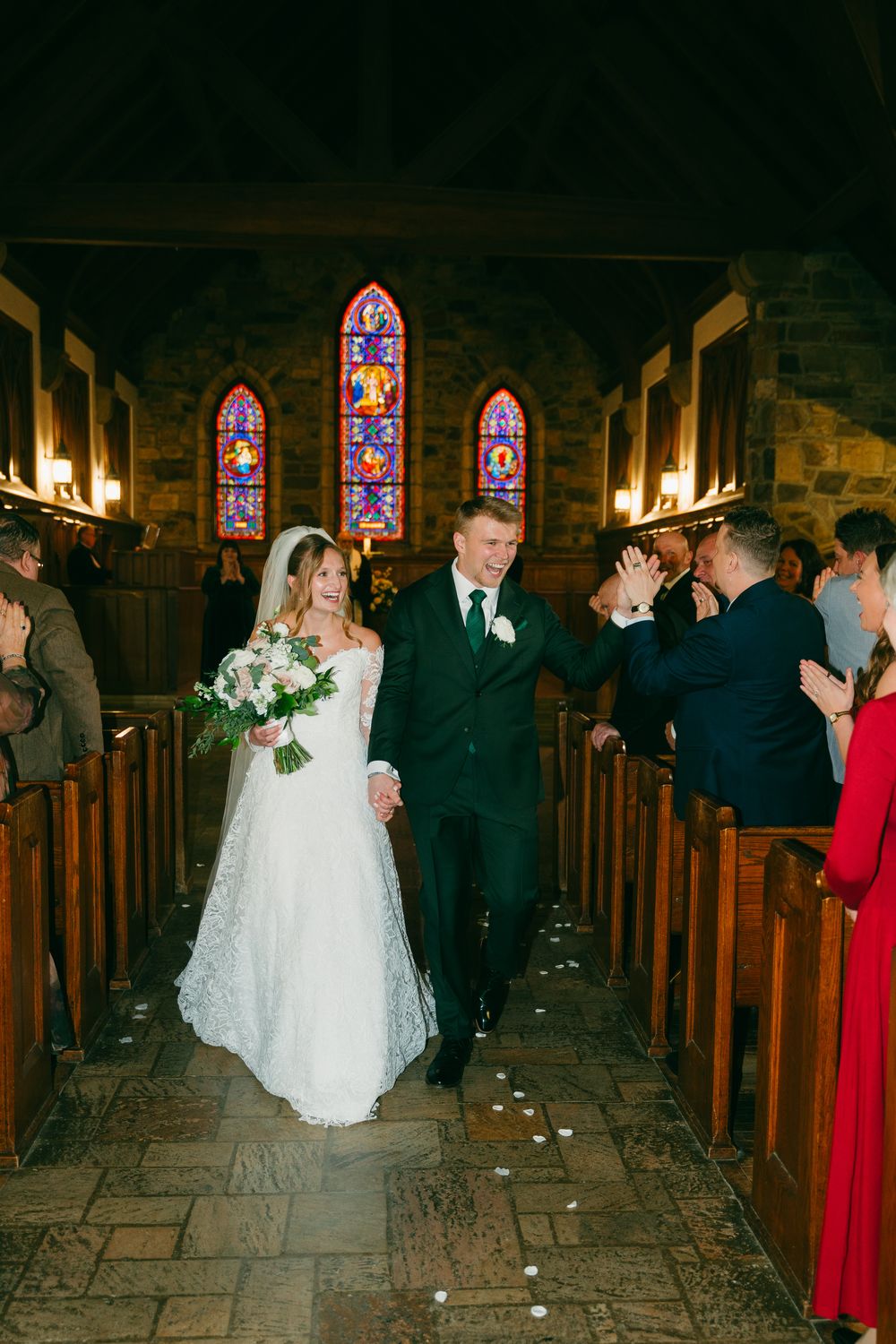 Eva and Jake walking back down the aisle, celebrating