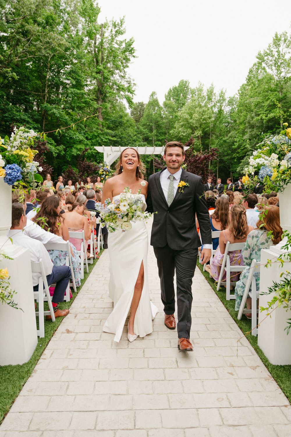 Hannah and Wesley walking back up the aisle as newlyweds