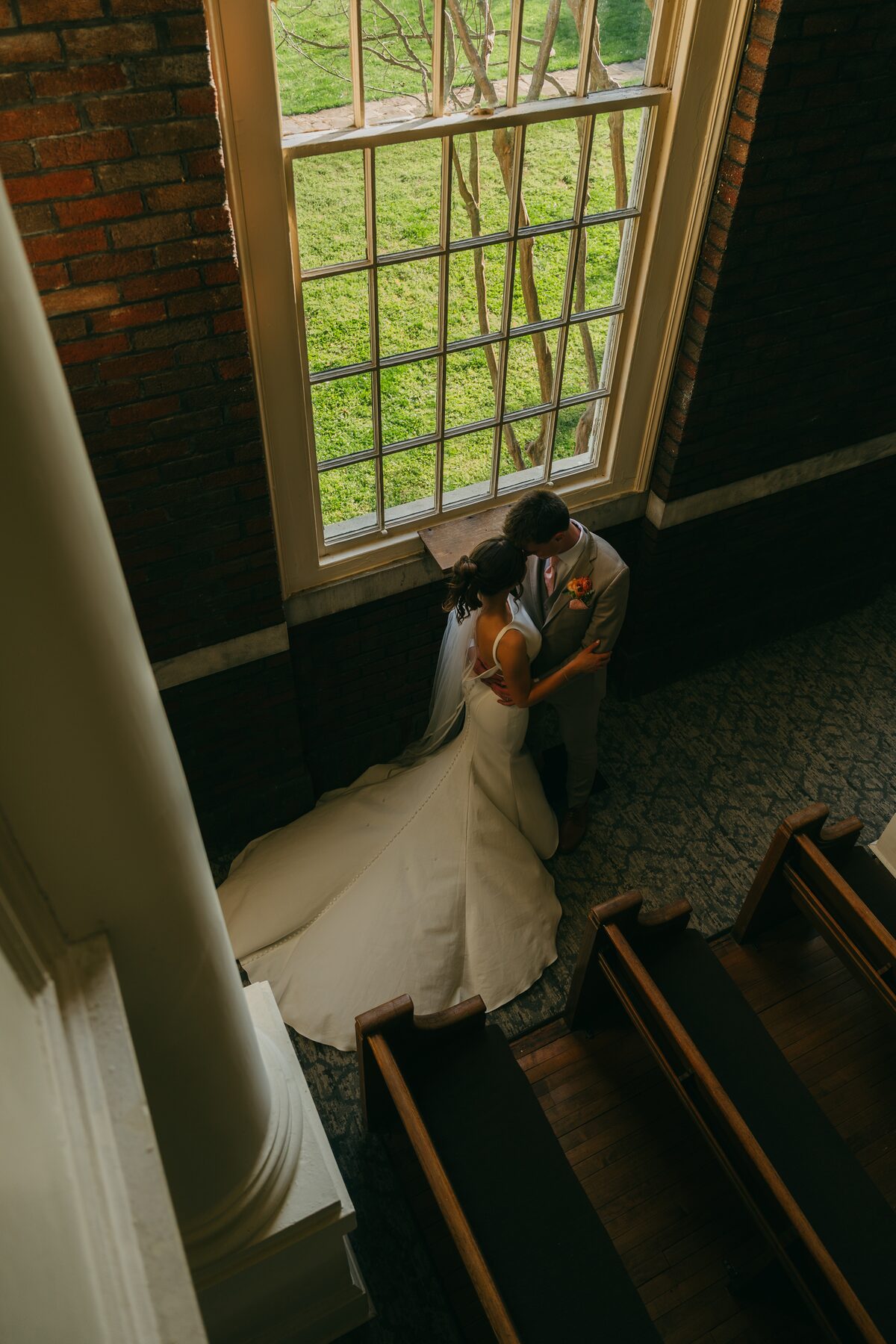 A bride and groom in a quiet embrace, photographed in black and white